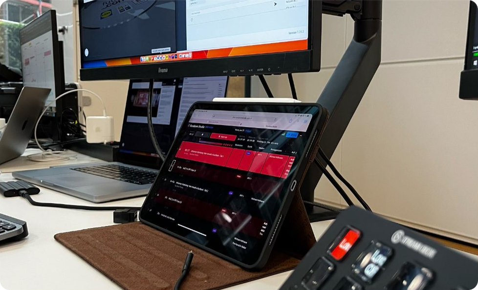 An iPad with rundown management tools set up beside broadcast equipment