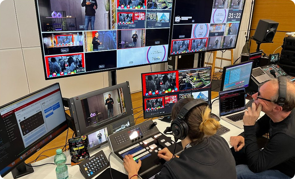 A control room with monitors and staff managing a live video production